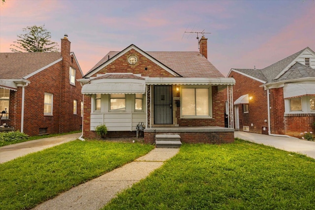 6905 Archdale St, Detroit, MI 48228 - bungalow-style house featuring a front yard, a chimney, and brick siding