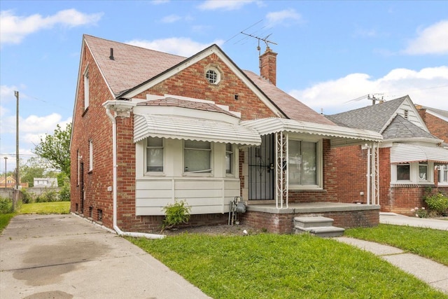 6905 Archdale St, Detroit, MI 48228 - view of front of house with brick siding, a chimney, a front yard, and roof with shingles