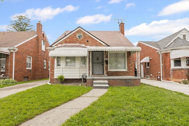6905 Archdale St, Detroit, MI 48228 - bungalow with a front yard, a chimney, and brick siding
