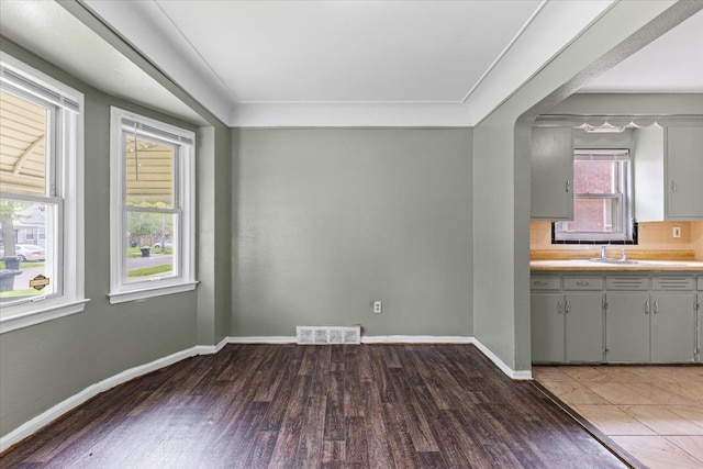 6905 Archdale St, Detroit, MI 48228 - kitchen with wood finished floors, gray cabinetry, baseboards, light countertops, and tasteful backsplash