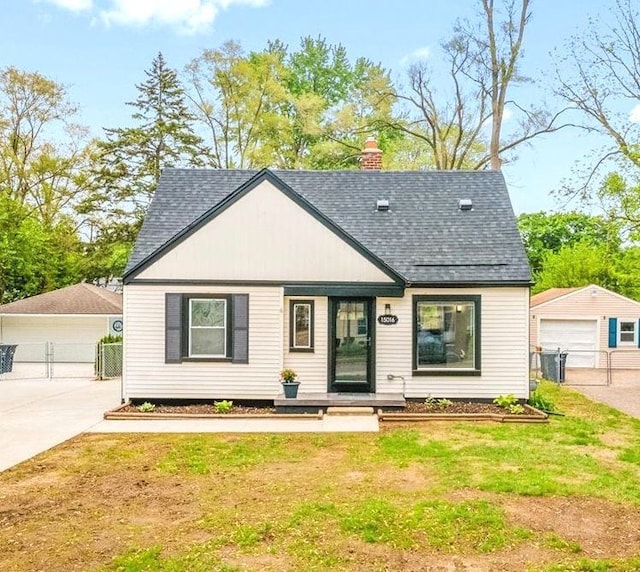 15016 Sunbury St, Livonia, MI 48154 - view of front of property with roof with shingles, a garage, an outdoor structure, and a chimney