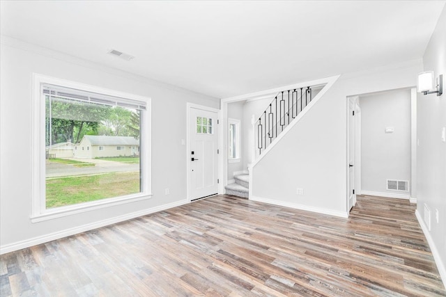 15016 Sunbury St, Livonia, MI 48154 - entrance foyer with wood finished floors, stairs, baseboards, and crown molding