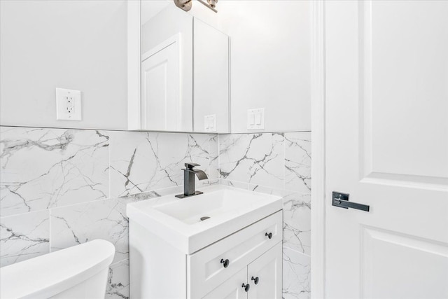 15016 Sunbury St, Livonia, MI 48154 - bathroom with tile walls, vanity, toilet, and marble finish floors