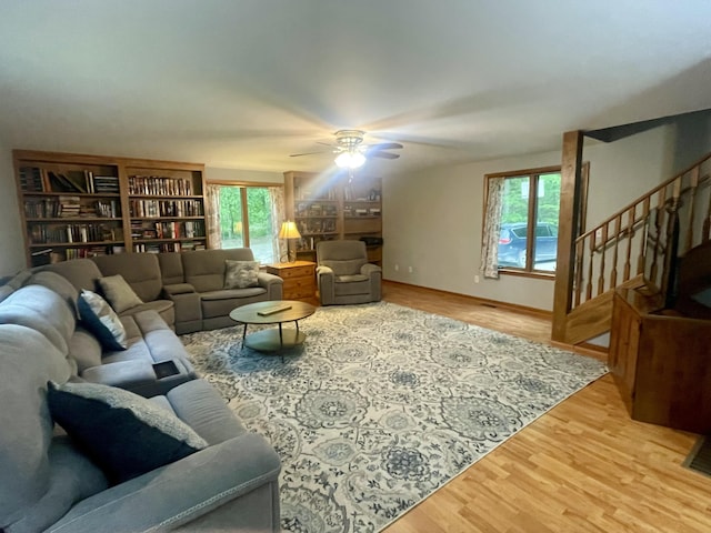 19490 Island Lake Rd, Chelsea, MI 48118 - living area with healthy amount of natural light, light wood finished floors, a ceiling fan, and stairway