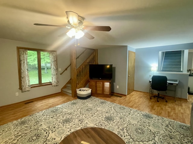 19490 Island Lake Rd, Chelsea, MI 48118 - living room with wood finished floors, ceiling fan, stairway, and baseboards