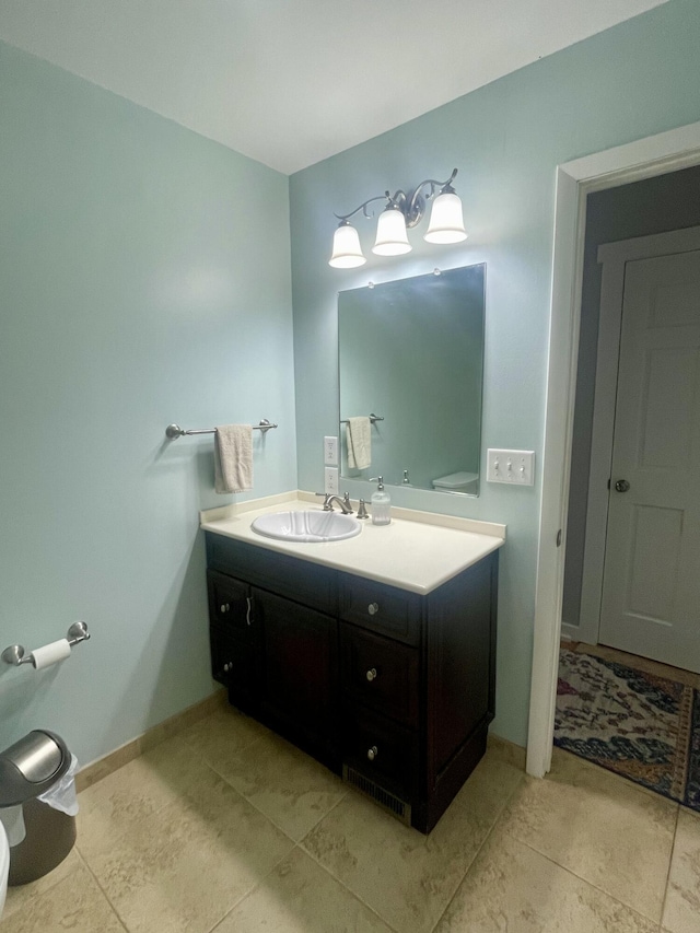 19490 Island Lake Rd, Chelsea, MI 48118 - bathroom with vanity, toilet, tile patterned flooring, and baseboards