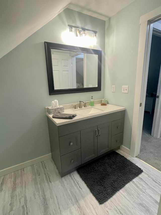 19490 Island Lake Rd, Chelsea, MI 48118 - bathroom with vanity, baseboards, and lofted ceiling