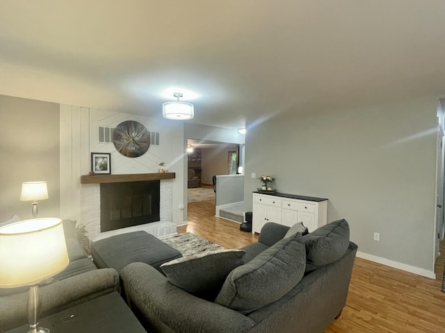 19490 Island Lake Rd, Chelsea, MI 48118 - living room with a fireplace, wood finished floors, and baseboards