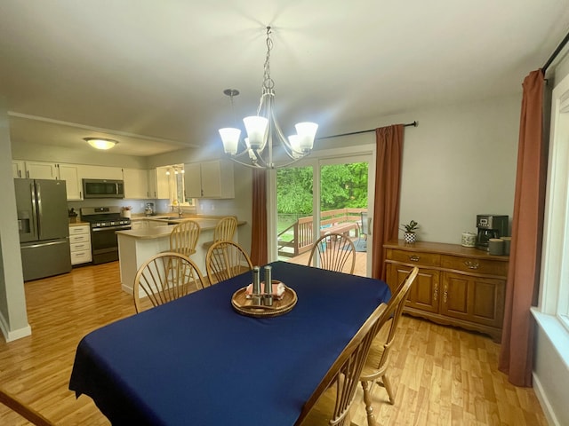 19490 Island Lake Rd, Chelsea, MI 48118 - dining space with a chandelier and light wood-type flooring