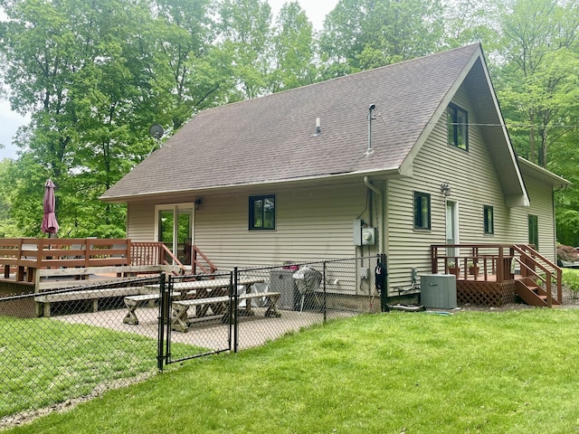 19490 Island Lake Rd, Chelsea, MI 48118 - rear view of house featuring a gate, central AC, a wooden deck, roof with shingles, and view of wooded area