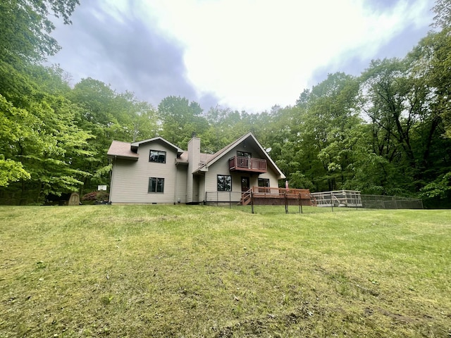 19490 Island Lake Rd, Chelsea, MI 48118 - rear view of house featuring a yard, a deck, a chimney, and a forest view