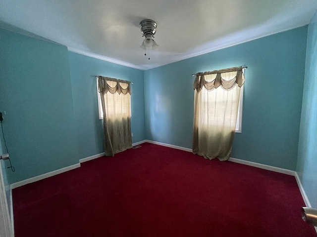 8056 Fisher Ave, Warren, MI 48089 - unfurnished room with healthy amount of natural light, a ceiling fan, and dark colored carpet