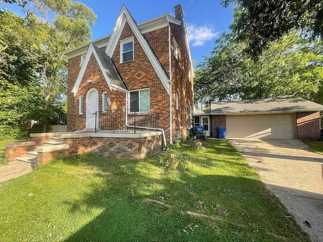 8056 Fisher Ave, Warren, MI 48089 - tudor-style house with brick siding, driveway, a front lawn, an attached garage, and a chimney