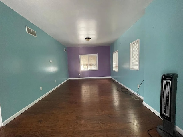 8056 Fisher Ave, Warren, MI 48089 - unfurnished room featuring wood finished floors, heating unit, and baseboards