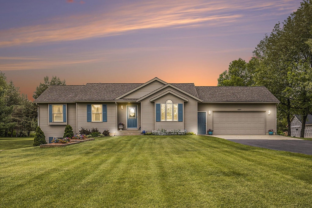 12697 Lindy Anne Ct NE, Cedar Springs, MI 49319 - single story home with an attached garage, asphalt driveway, a lawn, and a shingled roof