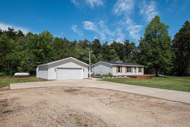 4171 E 124th St, Grant, MI 49327 - view of front facade featuring an outdoor structure, a front lawn, and a garage