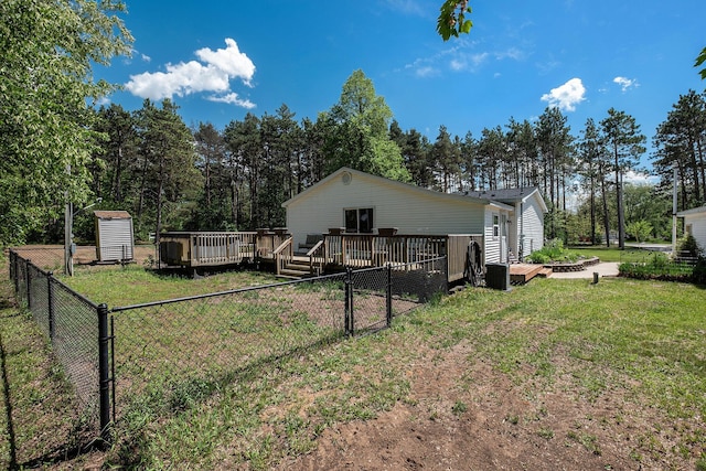 4171 E 124th St, Grant, MI 49327 - back of house with a deck and view of scattered trees