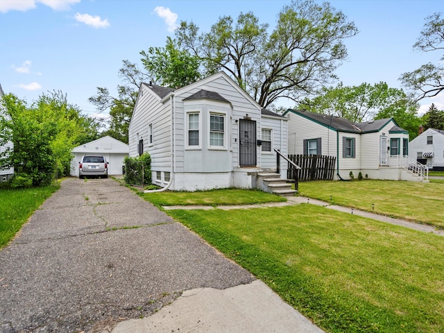 18914 Elkhart, Harper Woods, MI 48225 - view of front facade with a detached garage, a front yard, and an outbuilding