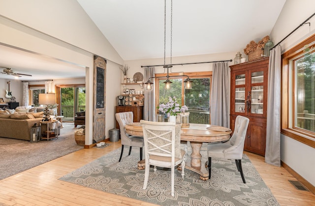 5511 Westside Dr, Alger, MI 48610 - dining room featuring vaulted ceiling, light wood-style floors, healthy amount of natural light, and baseboards
