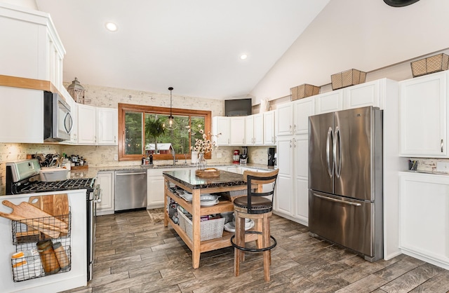 5511 Westside Dr, Alger, MI 48610 - kitchen with stainless steel appliances, a sink, white cabinets, backsplash, and recessed lighting