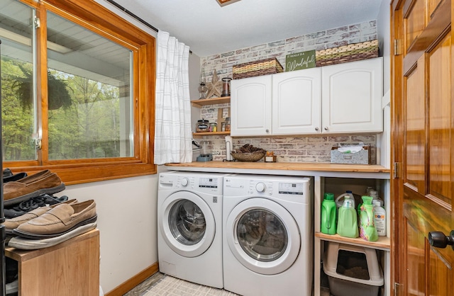 5511 Westside Dr, Alger, MI 48610 - laundry area featuring cabinet space, washer and dryer, and baseboards