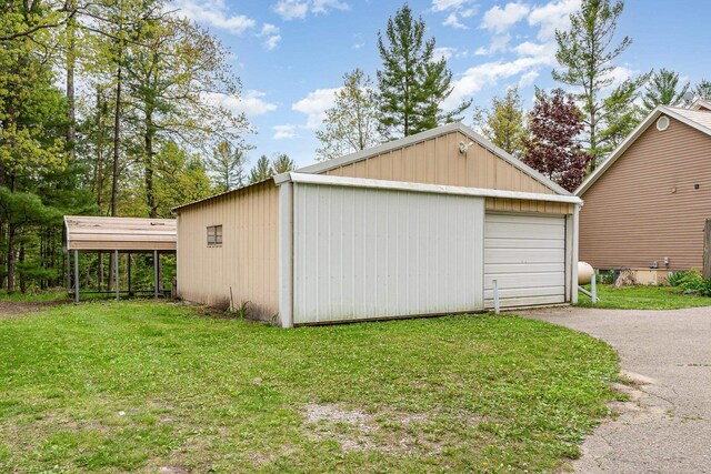 5511 Westside Dr, Alger, MI 48610 - detached garage featuring driveway