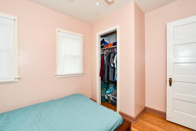 bedroom with light wood-style floors, a closet, and a walk in closet