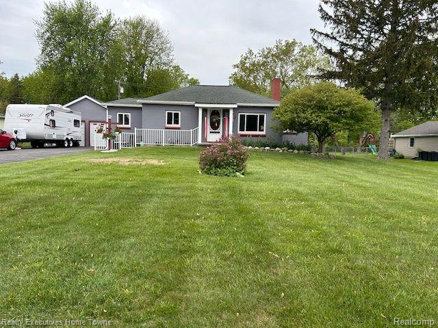 802 Colorado St, Marysville, MI 48040 - single story home with a chimney, a front yard, and driveway