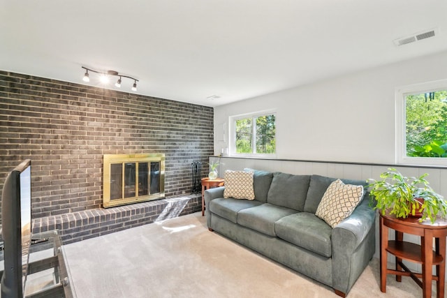 2761 Deake Ave, Ann Arbor, MI 48108 - living area with a fireplace, healthy amount of natural light, and a wainscoted wall