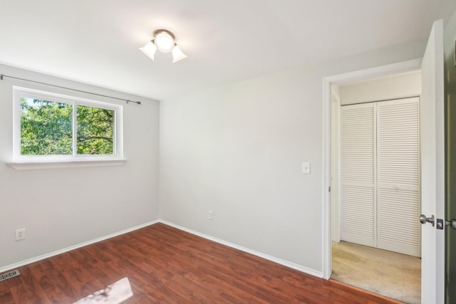 2761 Deake Ave, Ann Arbor, MI 48108 - unfurnished bedroom featuring wood finished floors, baseboards, and a closet