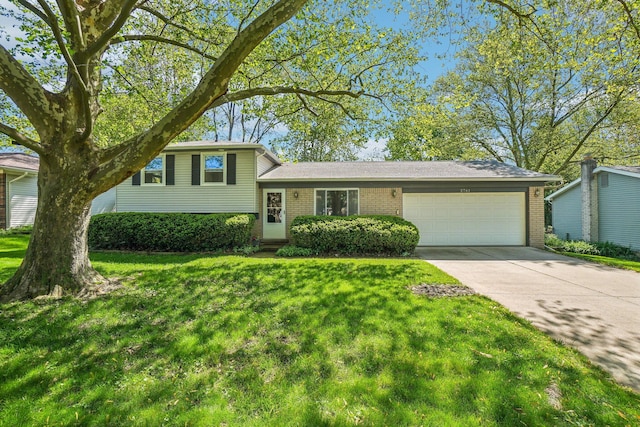 2761 Deake Ave, Ann Arbor, MI 48108 - split level home featuring brick siding, a garage, a front yard, and concrete driveway