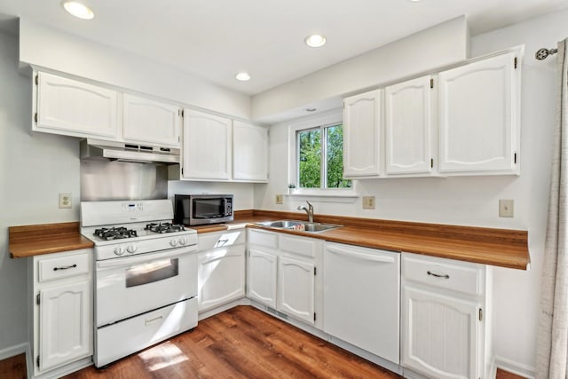 2761 Deake Ave, Ann Arbor, MI 48108 - kitchen featuring white appliances, under cabinet range hood, a sink, white cabinets, and dark wood-type flooring