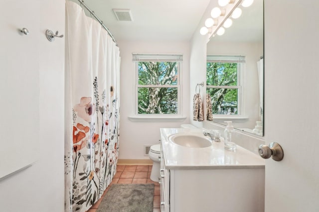 2761 Deake Ave, Ann Arbor, MI 48108 - full bath with healthy amount of natural light, vanity, toilet, and tile patterned flooring