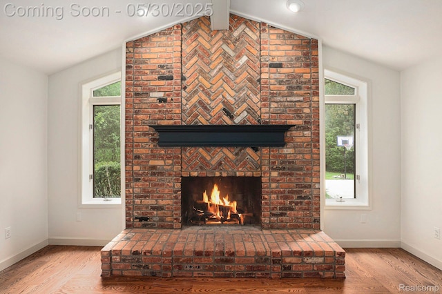 7254 Dark Lake Dr, Clarkston, MI 48346 - detailed view of wood finished floors, a fireplace, and baseboards