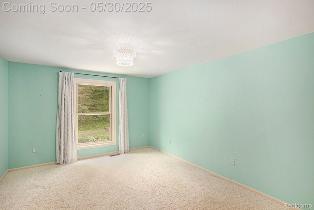 7254 Dark Lake Dr, Clarkston, MI 48346 - carpeted empty room featuring a chandelier and baseboards