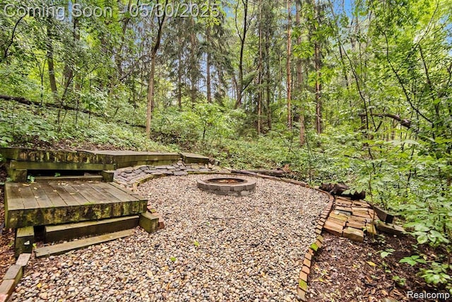 7254 Dark Lake Dr, Clarkston, MI 48346 - view of yard featuring an outdoor fire pit and a wooded view