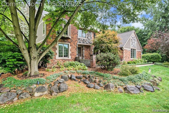 7254 Dark Lake Dr, Clarkston, MI 48346 - tudor-style house with a front yard and brick siding