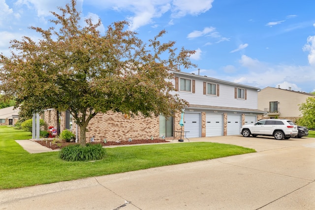 50102 S Angelo, Chesterfield, MI 48047 - townhome / multi-family property with an attached garage, a front lawn, concrete driveway, and brick siding