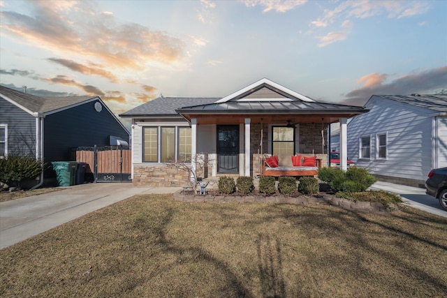 1826 Morris Ave, Lincoln Park, MI 48146 - view of front of property with stone siding, covered porch, a standing seam roof, and metal roof
