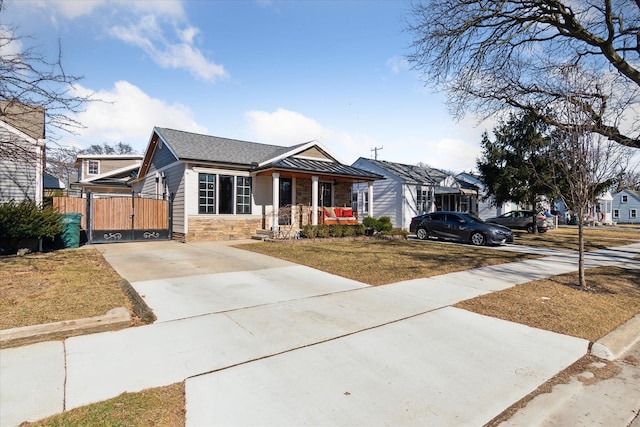 1826 Morris Ave, Lincoln Park, MI 48146 - view of front of house with driveway, stone siding, a gate, and a porch