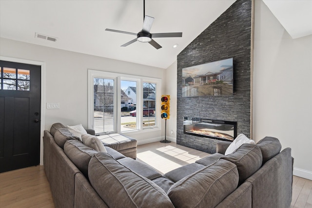 1826 Morris Ave, Lincoln Park, MI 48146 - living room with a fireplace, wood finished floors, ceiling fan, baseboards, and plenty of natural light
