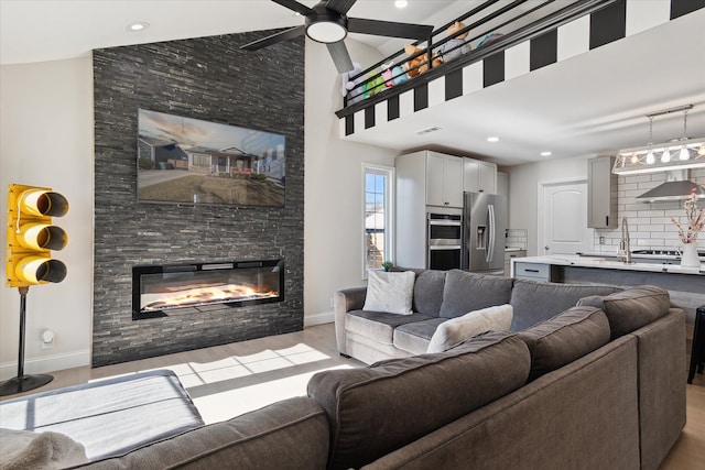 1826 Morris Ave, Lincoln Park, MI 48146 - living area with a fireplace, light wood finished floors, a ceiling fan, baseboards, and recessed lighting