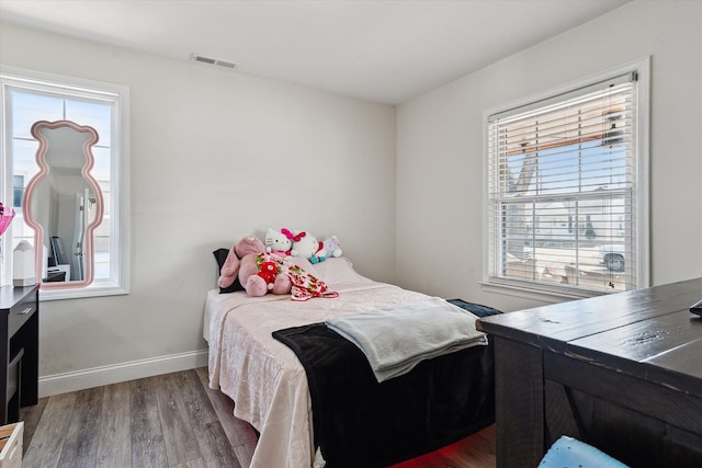 1826 Morris Ave, Lincoln Park, MI 48146 - bedroom featuring multiple windows, baseboards, and wood finished floors