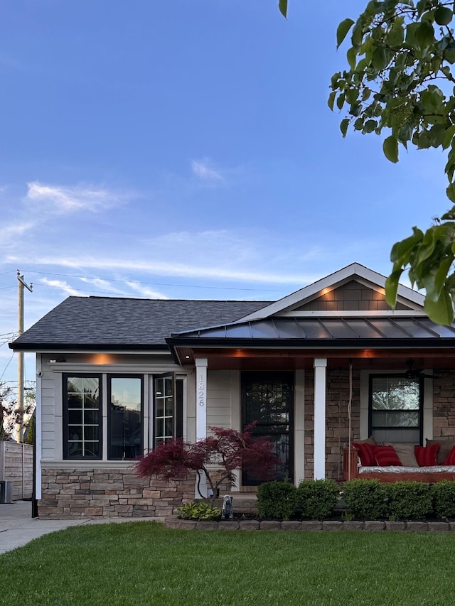 1826 Morris Ave, Lincoln Park, MI 48146 - view of front of home with stone siding, a front lawn, and a shingled roof