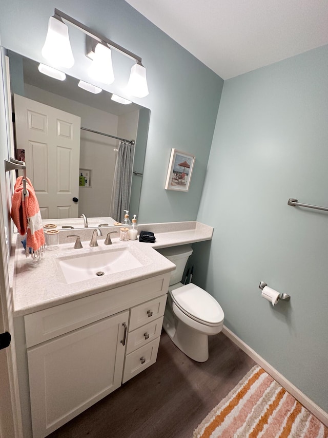 130 N Shore Dr Unit 8, South Haven, MI 49090 - full bathroom featuring wood finished floors, toilet, vanity, a shower with curtain, and baseboards