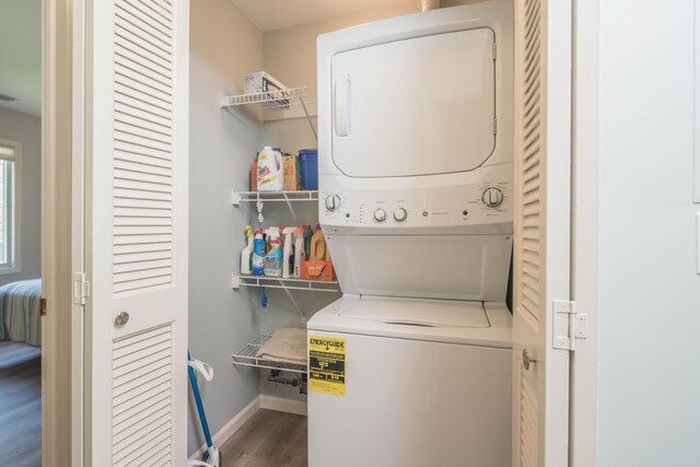 130 N Shore Dr Unit 8, South Haven, MI 49090 - washroom featuring stacked washer / drying machine, wood finished floors, and baseboards