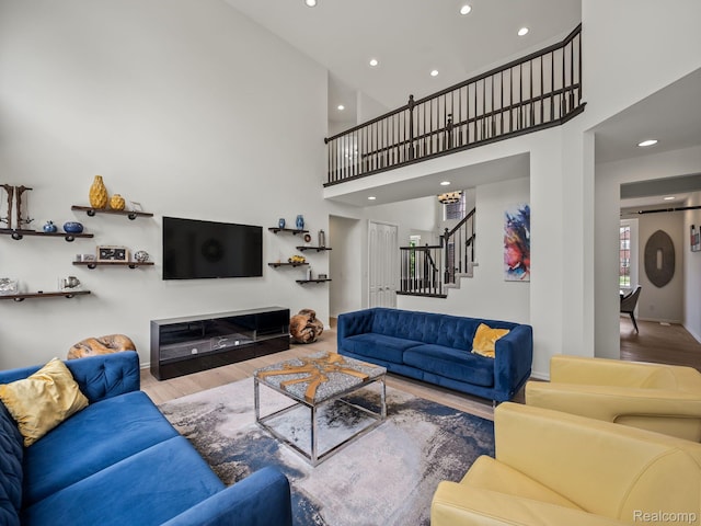 1231 Burns Dr, Troy, MI 48083 - living area with wood finished floors, stairway, recessed lighting, a high ceiling, and baseboards