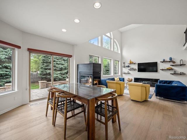1231 Burns Dr, Troy, MI 48083 - dining area featuring a glass covered fireplace, light wood-style flooring, recessed lighting, and baseboards
