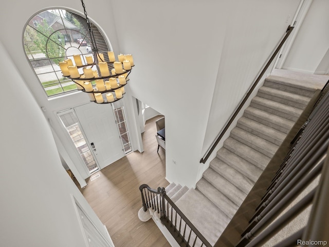 1231 Burns Dr, Troy, MI 48083 - foyer with a chandelier, stairs, wood finished floors, and a high ceiling