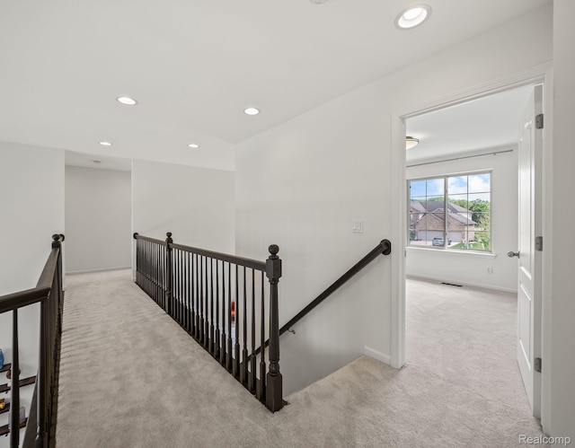 1231 Burns Dr, Troy, MI 48083 - hallway with an upstairs landing, light carpet, recessed lighting, and baseboards